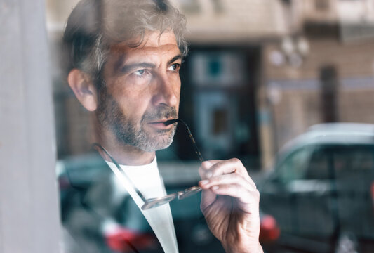 Confident mature businessman looking forwards in his modern office