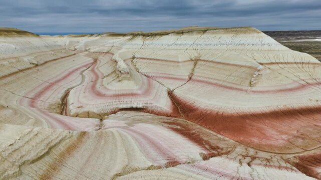 The colorful Kyzylkup Canyon in the clouds is a natural landmark in Kazakhstan's Mangystau region. A group of colorful hills with multi-layered slopes reminiscent of the Italian dessert tiramisu