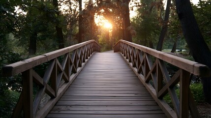 Fototapeta premium A rustic wooden footbridge spans a peaceful forest path bathed in the warm glow of a dramatic sunset