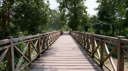 Fototapeta premium A wooden bridge extends into a dense lush forest offering an adventurous path through the natural wilderness