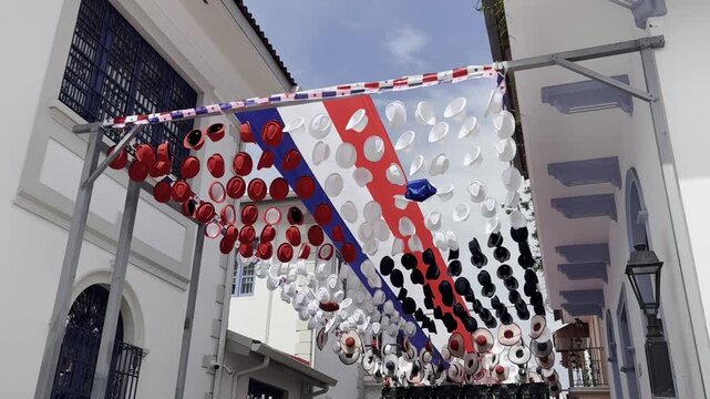 A charming and authentic video of an old-town street in Panama City, lined with hanging traditional hats. The swaying hats evoke craftsmanship, tradition, and local identity. 