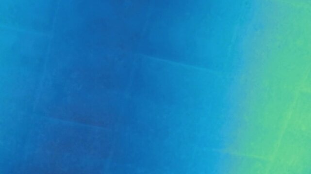 A vibrant blue and green gradient background with a subtle grid pattern