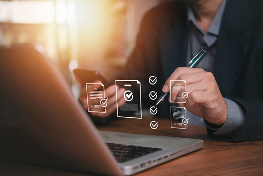 Businessman using pen for electronic signature on digital document and online contract approval