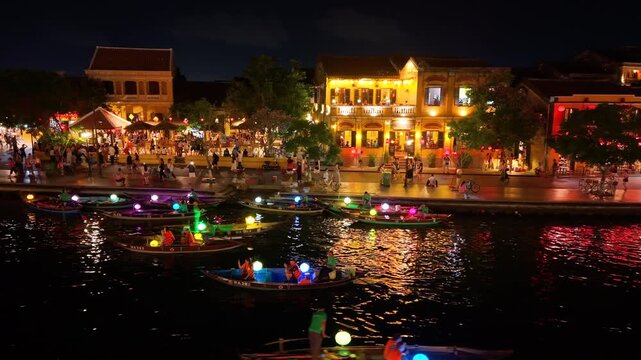 Panorama aerial drone view of Hoi An ancient town with boat tour and beautiful lanterns in night. UNESCO world heritage. One of the most travel popular touristic destinations