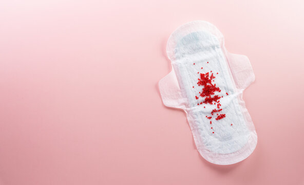 White sanitary pad on pastel background. Woman health or body positive concept.