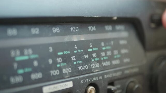 Macro of a classic radio receiver tuning scale, searching for a broadcast station.