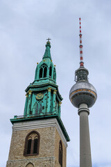 Berlin's historic church tower stands beside the modern television tower under a winter sky © Wayne Jones