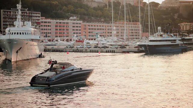 Sleek speed boat navigates harbor with large yachts and city skyline backdrop.
