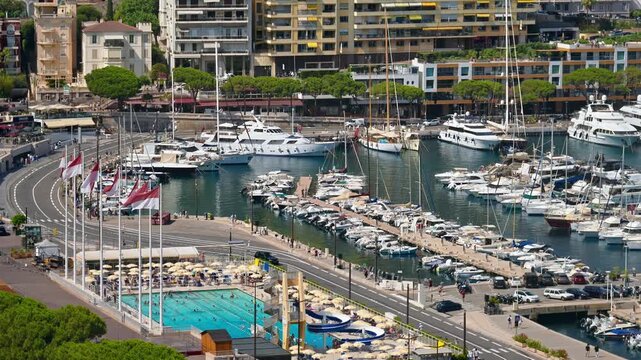 Monaco port city view with luxury yachts docked in harbor and blue swimming pool cinematic footage.