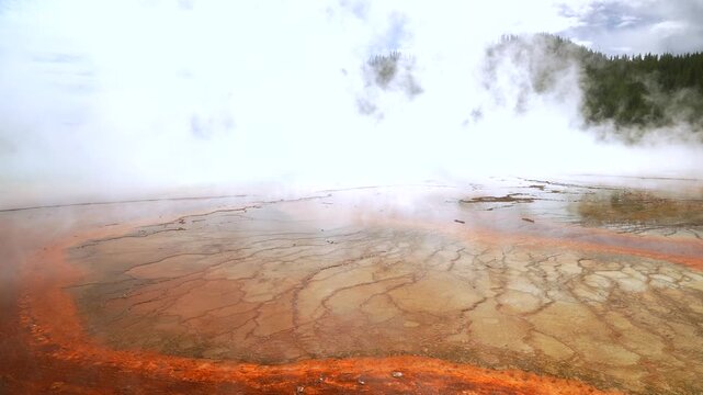 Grand Prismatic Spring vibrant colorful hot springs dense steam pool Midway Boardwalk Fairy Falls trail Mid Geyser Basin Wyoming USA Yellowstone National Park nature landscape sunny morning blue sky