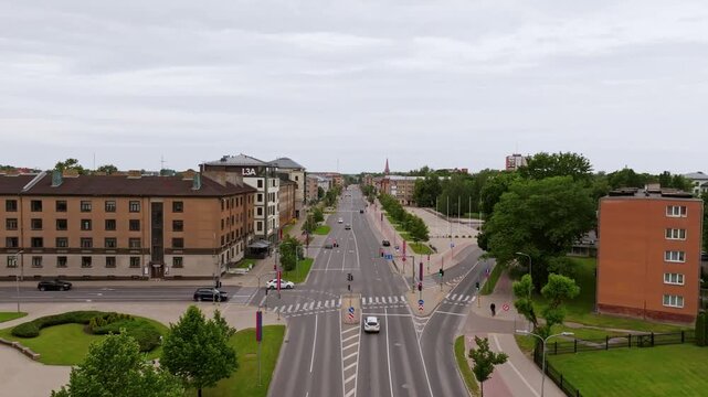Establishing shot capturing Jelgava city avenue, symmetrical urban composition