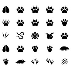 Fototapeta premium Collection of Various Animal Paw and Footprint Icons. A set of black vector icons featuring different animal paws and footprints on a white background