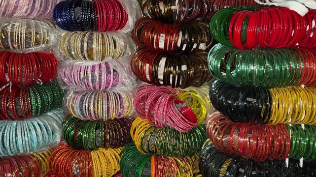beautiful ethnic bangles display with vibrant colors and shiny texture at street shop at festival