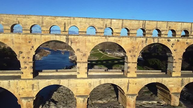 Roman aqueduct bridge over the river. Pont du Gard. Gard Bridge. Aerial view. The tallest Roman bridge in the world, with three levels of arches. Remoulins. France.