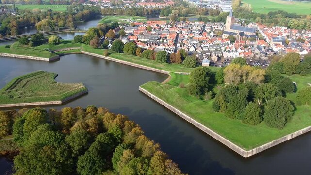 Naarden. Aerial view. Star-shaped fortified city surrounded by canals and bridges. Gothic Grote Kerk church. Star-shaped defensive fortress, 17th century.