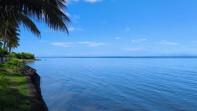 Scenic coastline view of blue ocean and sky on sunny day in capital city of Suva on tropical island Viti Levu in Fiji