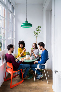 Four friends at home having coffee break