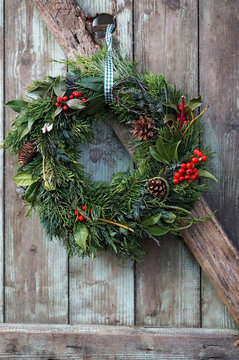 Christmas wreath on old wooden door, close up
