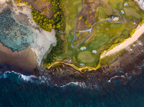 Indonesia, Bali, Aerial view of golf course with bunker and green at coast