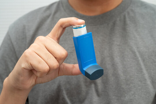 Asthma and chronic obstructive pulmonary disease COPD, Asian teenage using metered dose inhaler MDI.