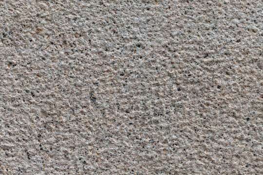 Uniformly chiseled granite stone background texture material macro