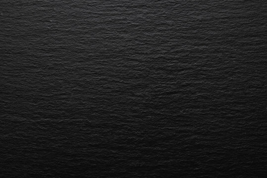 Black slate stone texture background, dark natural rock surface with organic relief pattern.
