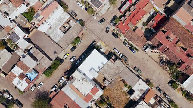 Drone reveals the rooftops and cobblestone streets of a neighborhood in mexico