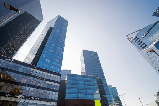 Tallin Estonia, July 15, 2025, A low-angle upward perspective of modern glass skyscrapers in the business district of Tallinn, Estonia, including the SEB bank building, set against a clear blue sky.