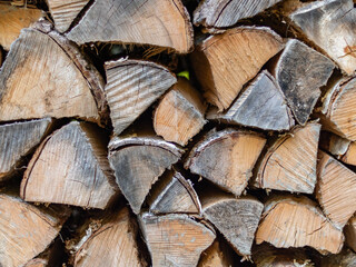 Fototapeta premium Stacked firewood texture with cut wooden logs