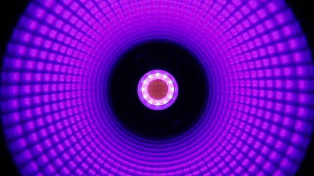 A macro close-up of a circular LED lamp core featuring bright white diodes surrounded by concentric textured blue reflector rings. Concept of modern illumination technology.