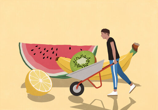 Young man pushing wheelbarrow full of fresh, healthy fruits