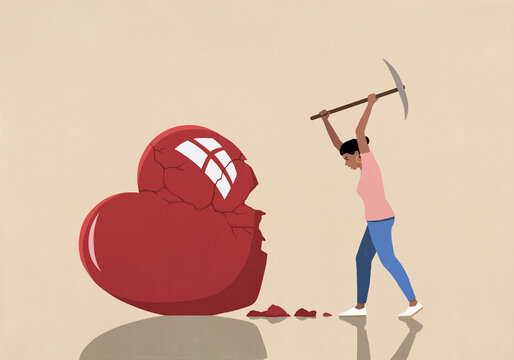 Angry woman smashing large heart with axe