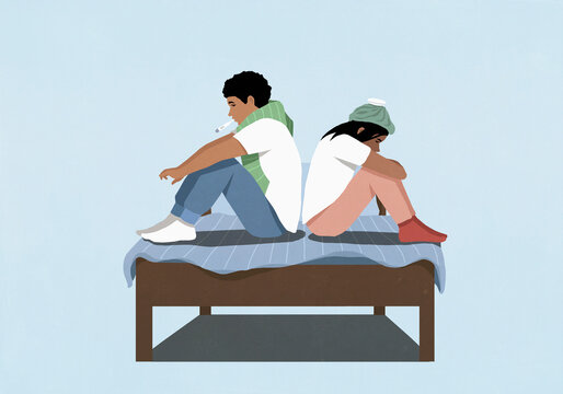 Sick couple with thermometer and ice pack sitting back to back on bed