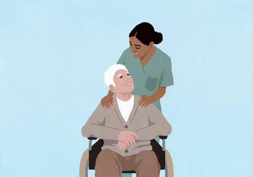 Friendly female nurse with senior man in wheelchair outside hospital