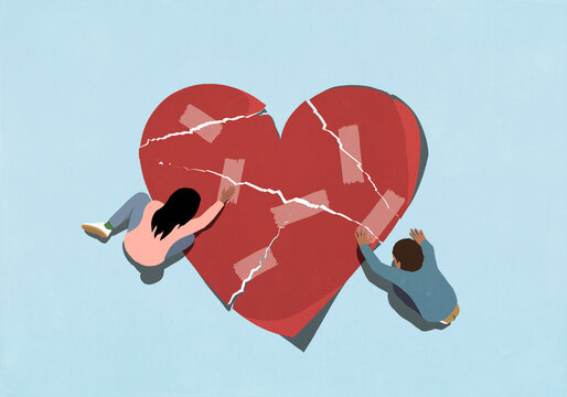 Young couple mending broken heart with adhesive tape