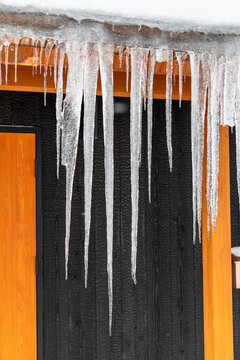 Long icicles hanging over edge of roof, Nozawaonsen, Japan