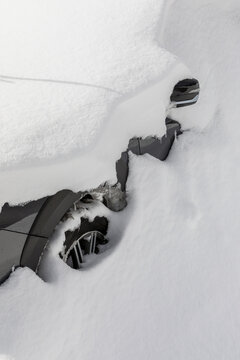 Barely visible car buried in snow