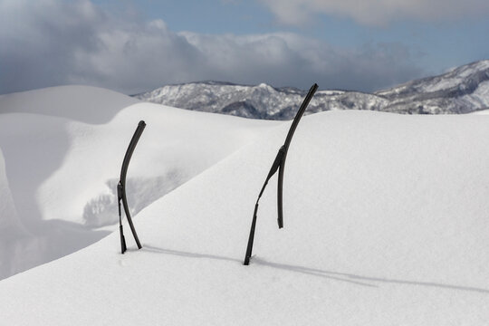 Windshield wipers sticking up out of snow