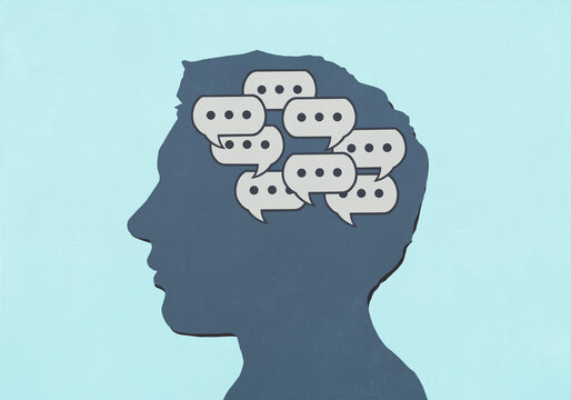 Group of chat bubbles inside silhouetted man's head against blue background