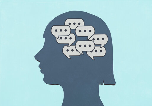 Group of chat bubbles inside silhouetted girl's head against blue background