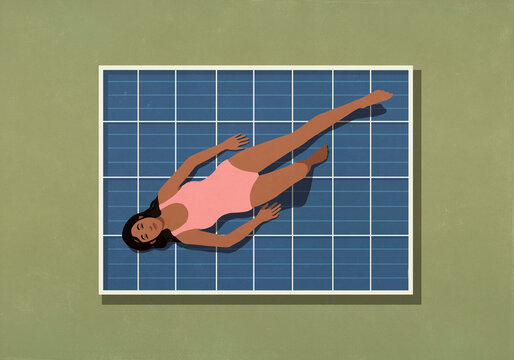 View from above of carefree woman sunbathing on solar panel