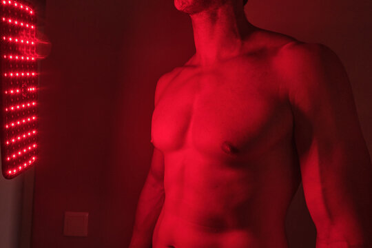 Man receiving red light therapy on torso