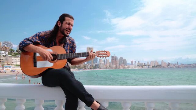 Gipsy artist in traditional clothing playing Spanish guitar. Static shot with copy space on the right.