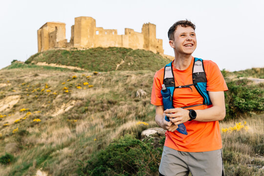 Trail runner enjoying outdoor exercise near ancient castle ruins