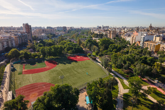 Aerial high angle view of baseball fields in Turia Riverbed Gardens with Serranos Towers in Valencia Spain