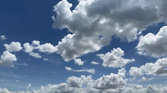 4K Timelapse Fluffy Cumulus Clouds Drifting 
Blue Sky Thailand Landscape 4K timelapse of white cumulus clouds drifting across 
a vivid blue tropical sky in Thailand. Minimal clean 
cloudscape with bri