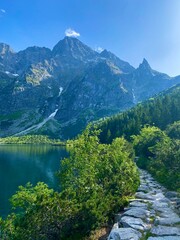 Rocky path with a view of mountain lake Morskie oko in Tatra National park, Zakopane, Poland. © Darja