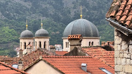 St Nicholas Church domes above terracotta roofs overlooking Kotor old town © tilialucida
