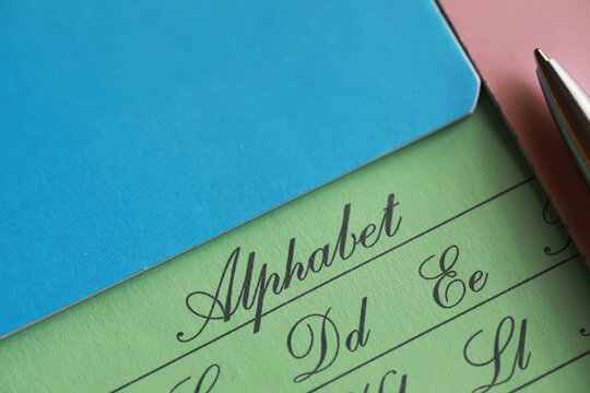 Cursive Alphabet Practice Sheet with Colorful Paper and Pen for Handwriting Education