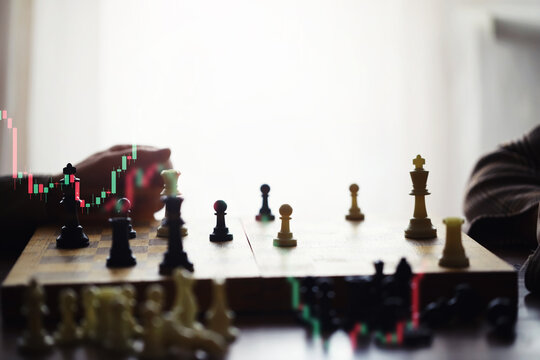 Black and White chess with player, Businessman and Businesswoman shaking hands after end game of thinking strategy to moving chess figure in competition with opposite player and planning.